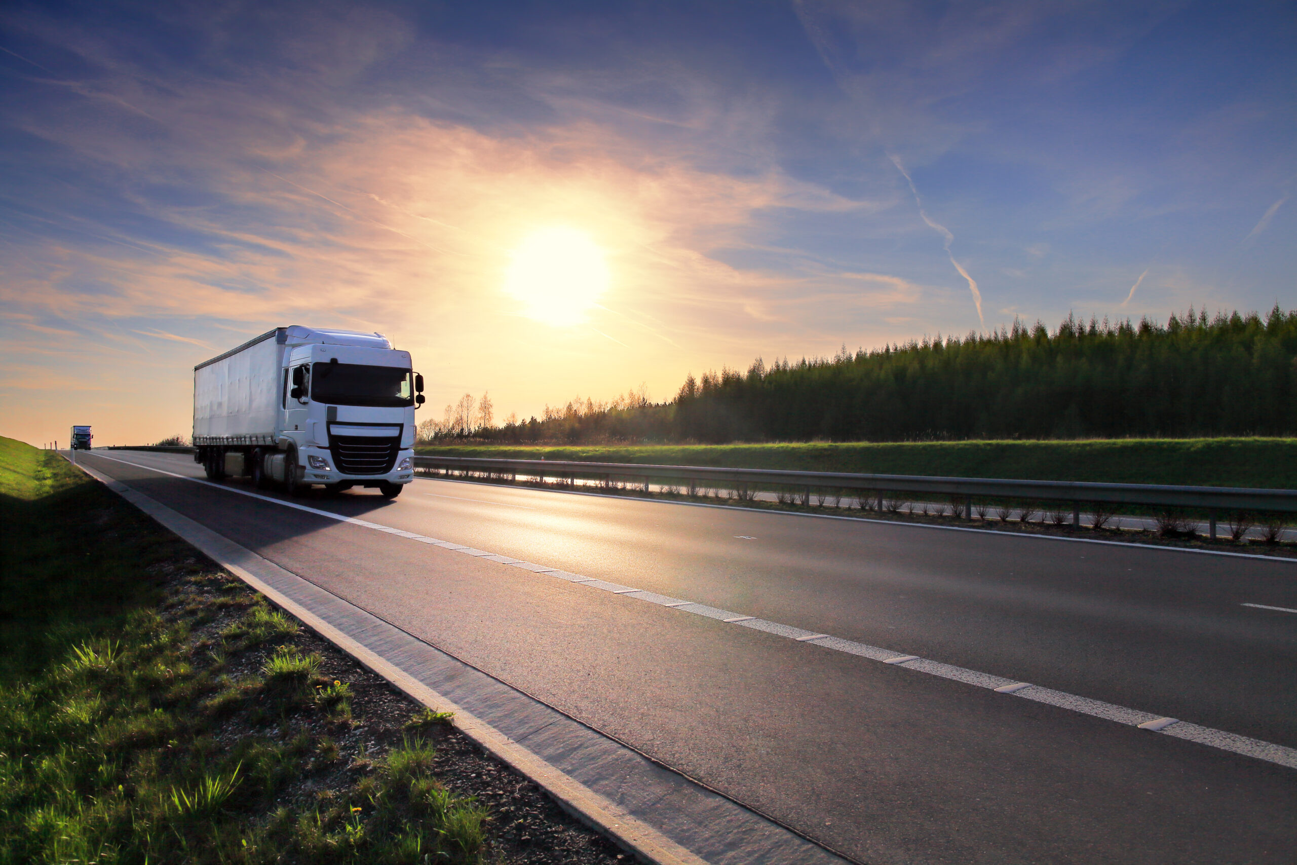 Truck transportation on the road at sunset